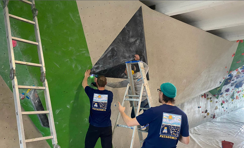 route setters adding a volume to a bouldering wall