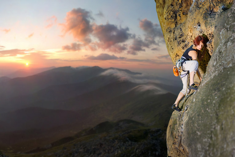 female climber trusting her feet on a climbing route. Fear of falling is nowhere to be seen.